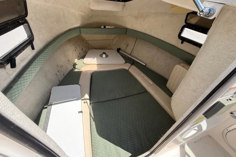 Slide: The Image of 2002 Bayliner Trophy Walkaround cabin interior with seating and storage compartments. - 14