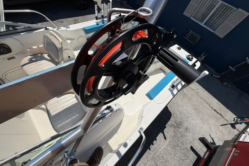 Slide: The Image of 2002 Bayliner Trophy Walkaround boat interior with fishing rod holder and seating. - 18