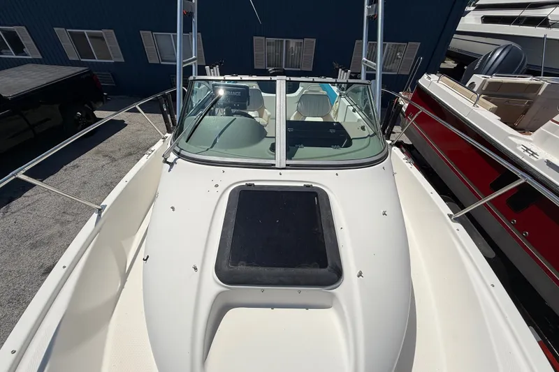 Slide: The Image of 2002 Bayliner Trophy Walkaround boat with spacious deck and windshield, docked at marina. - 19