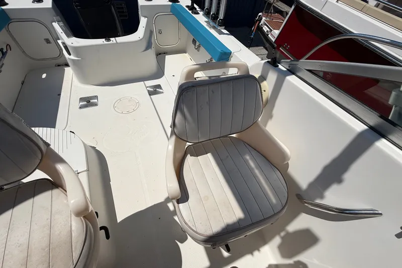 Slide: The Image of 2002 Bayliner Trophy Walkaround boat interior with seating and control area. - 16
