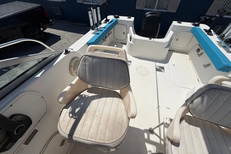 Slide: The Image of 2002 Bayliner Trophy Walkaround boat interior with seating and fishing rod holders. - 15