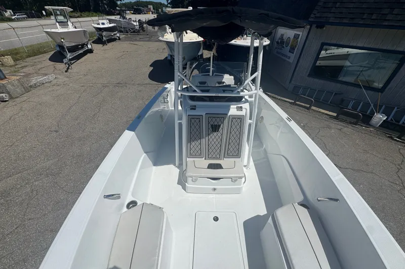Slide: The Image of 2023 Wellcraft 202 Fisherman boat, spacious deck, parked outdoors, showcasing modern design. - 10