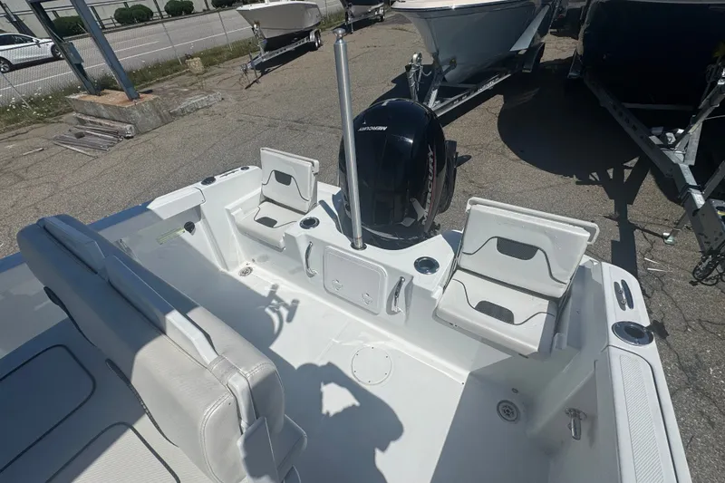 Slide: The Image of 2023 Wellcraft 202 Fisherman boat interior with seating and Mercury outboard motor. - 8