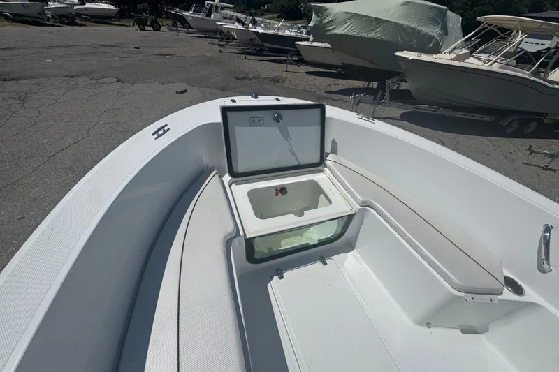 Slide: The Image of 2023 Wellcraft 202 Fisherman boat interior with open storage compartment and seating. - 7