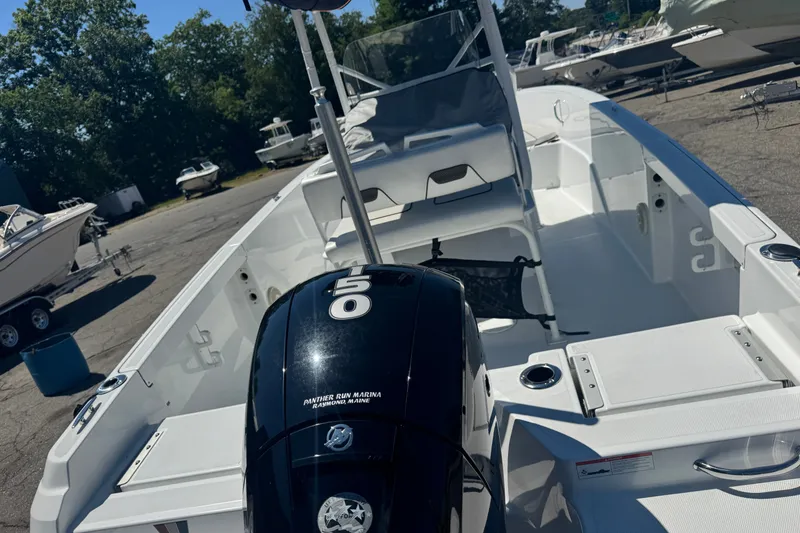 Slide: The Image of 2023 Wellcraft 202 Fisherman boat with powerful outboard motor, parked outdoors. - 6