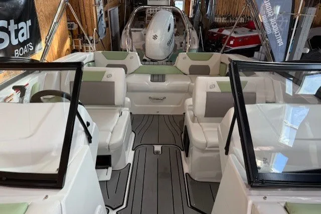Slide: The Image of 2026 Hurricane SunDeck Sport 2050 OB boat interior with seating and steering wheel. - 16