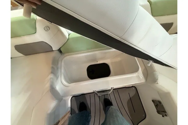 Slide: The Image of 2026 Hurricane SunDeck Sport 2050 OB boat storage compartment with open seat lid. - 23