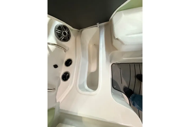 Slide: The Image of Interior view of 2026 Hurricane SunDeck Sport 2050 OB boat, featuring seating and speaker system. - 22