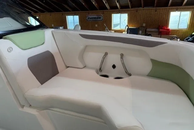 Slide: The Image of 2026 Hurricane SunDeck Sport 2050 OB boat interior with cushioned seating in a showroom. - 20