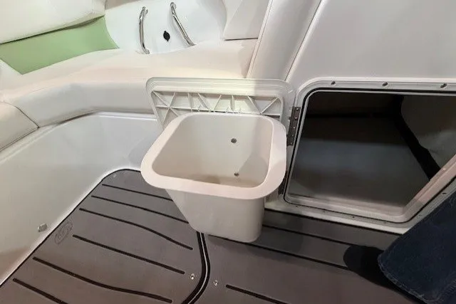 Slide: The Image of Interior of 2026 Hurricane SunDeck Sport 2050 OB with storage compartment and removable bin. - 26