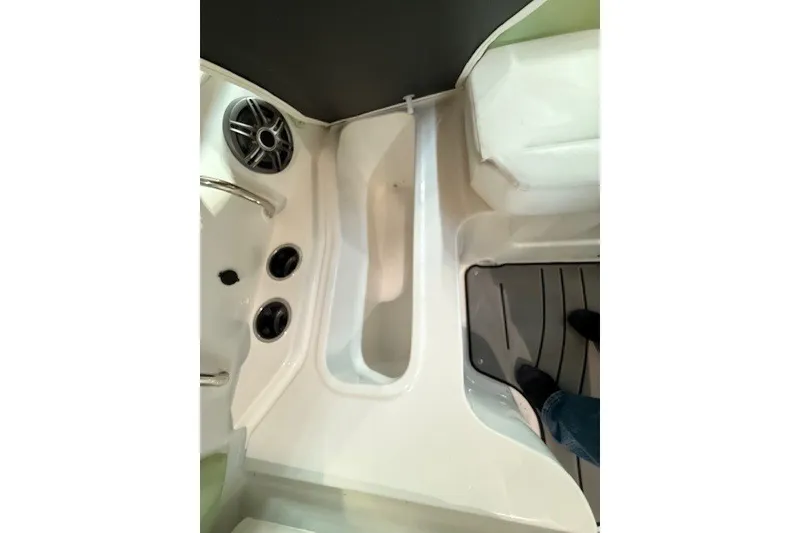 Slide: The Image of Interior view of 2026 Hurricane SunDeck Sport 2050 OB boat, featuring seating and speaker system. - 21