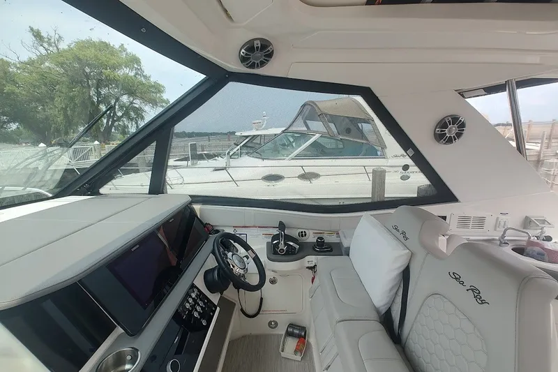 Slide: The Image of Interior of 2024 Sea Ray Sundancer 320 Coupe with modern helm and seating. - 18