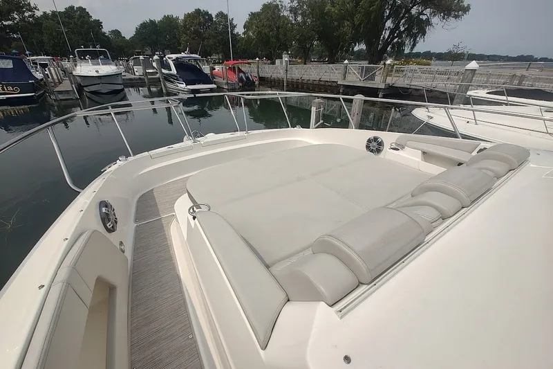 Slide: The Image of 2024 Sea Ray Sundancer 320 Coupe at marina, featuring spacious deck and luxurious seating. - 28