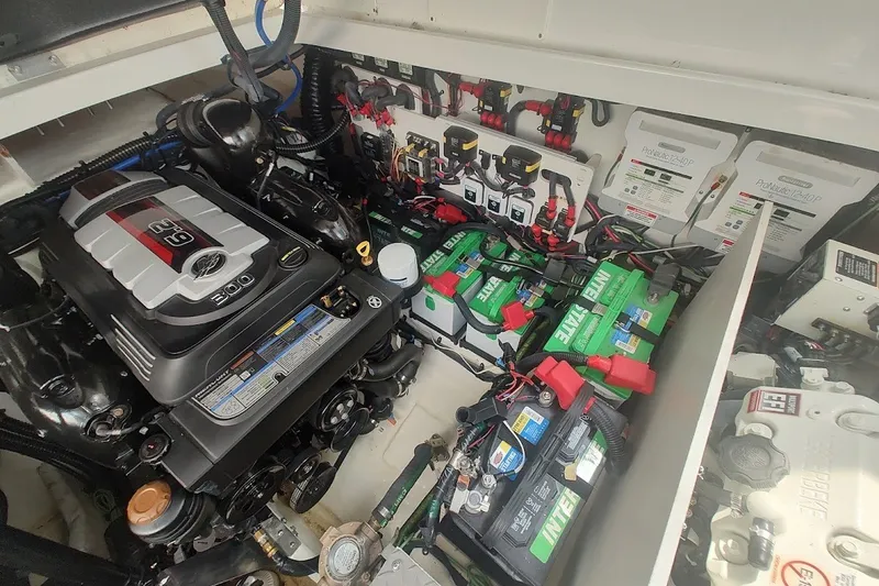 Slide: The Image of Engine compartment of 2024 Sea Ray Sundancer 320 Coupe with batteries and wiring. - 38