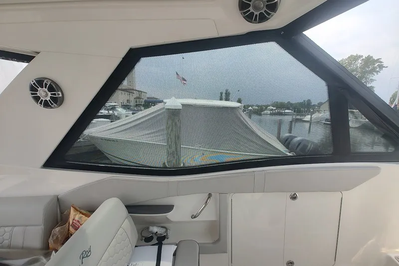Slide: The Image of Interior view of 2024 Sea Ray Sundancer 320 Coupe, showcasing marina through window. - 19