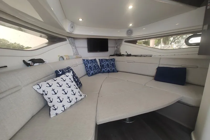 Slide: The Image of Luxurious interior of 2024 Sea Ray Sundancer 320 Coupe with cozy seating and nautical decor. - 33