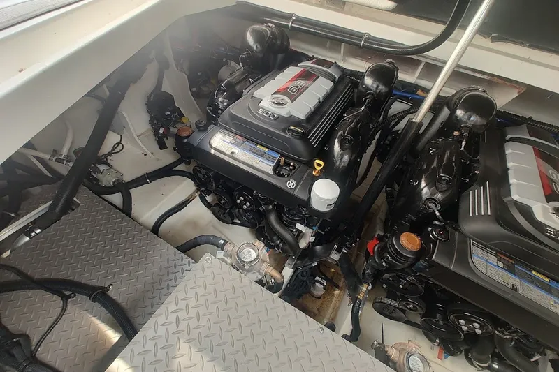 Slide: The Image of Engine compartment of 2024 Sea Ray Sundancer 320 Coupe, showcasing dual engines and mechanical components. - 36