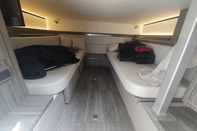 Slide: The Image of 2024 Sea Ray Sundancer 320 Coupe cabin interior with modern seating and ambient lighting. - 32