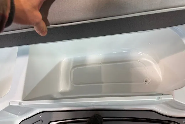 Slide: The Image of Storage compartment in 2026 Hurricane SunDeck 2400 OB boat, open lid view. - 19