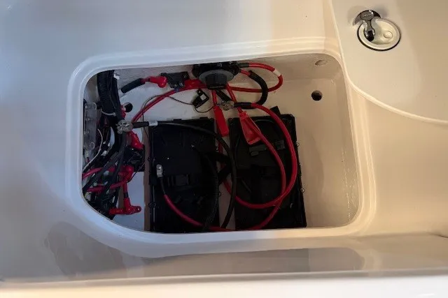 Slide: The Image of Battery compartment of 2026 Hurricane SunDeck 2400 OB boat with wiring and connections. - 20