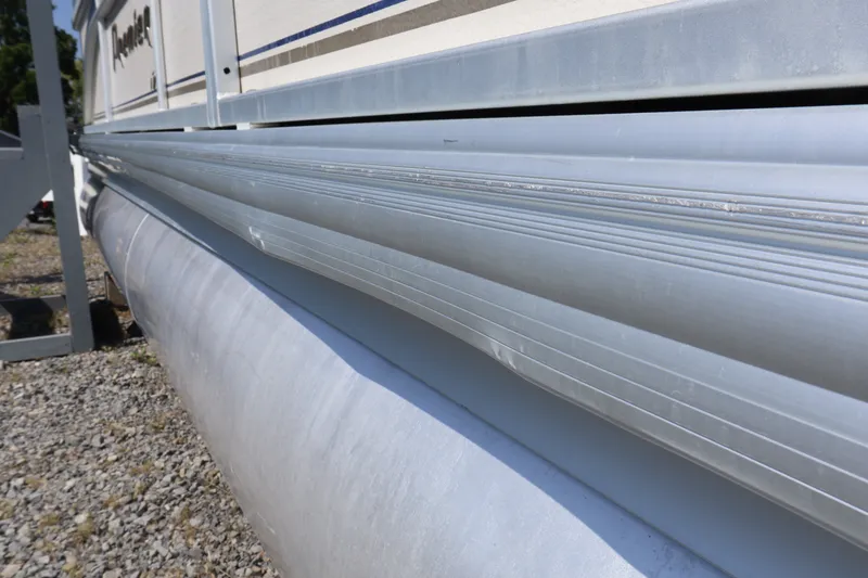 Slide: The Image of Side view of a 2008 Premier 210 Sunsation pontoon boat on gravel. - 11