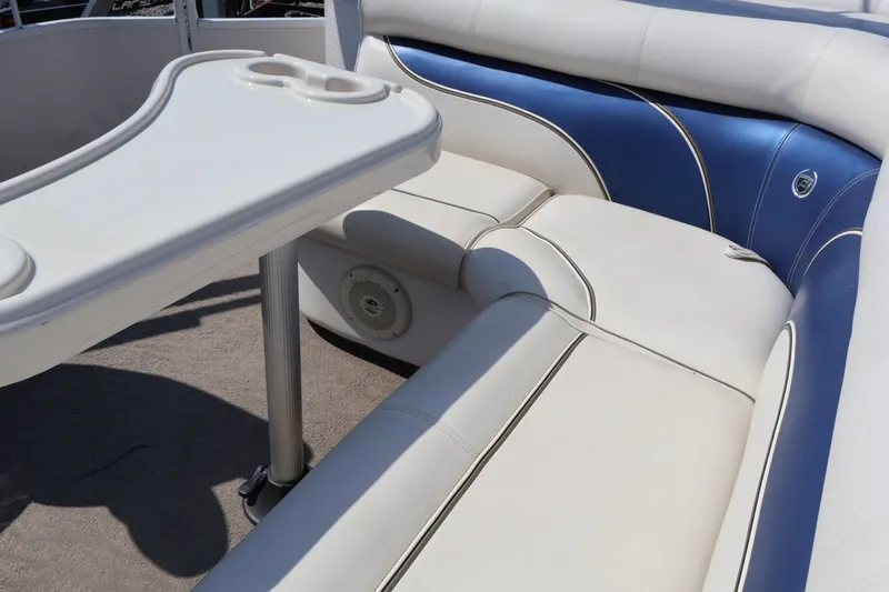 Slide: The Image of 2008 Premier 210 Sunsation boat interior with white and blue seating and table. - 21