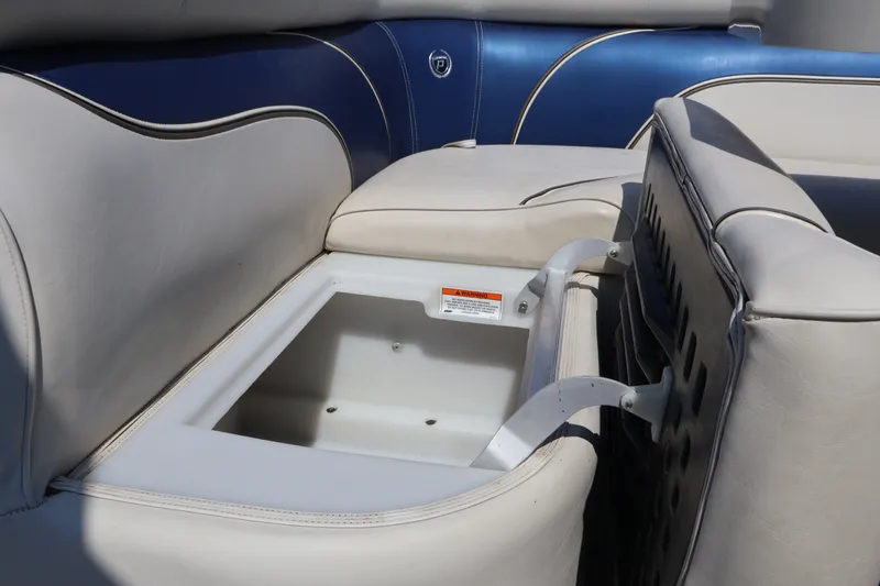 Slide: The Image of 2008 Premier 210 Sunsation boat seat storage compartment with blue and white upholstery. - 40