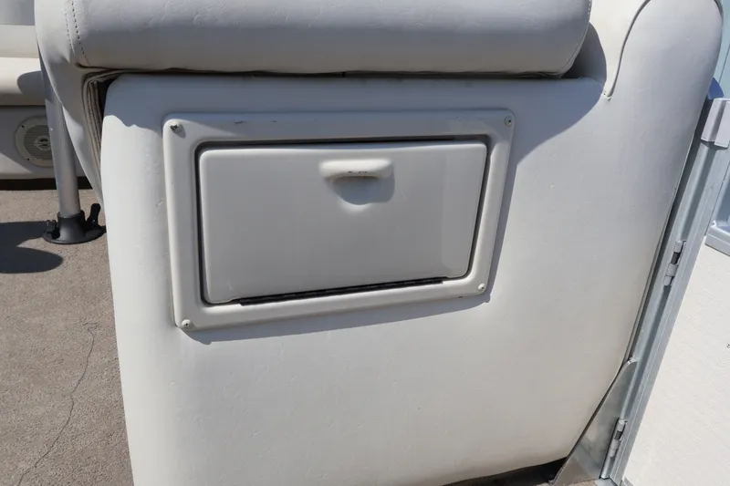 Slide: The Image of 2008 Premier 210 Sunsation boat storage compartment with white cushioned seating. - 50