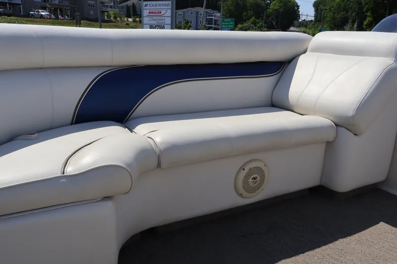 Slide: The Image of 2008 Premier 210 Sunsation boat interior with white and blue cushioned seating. - 54