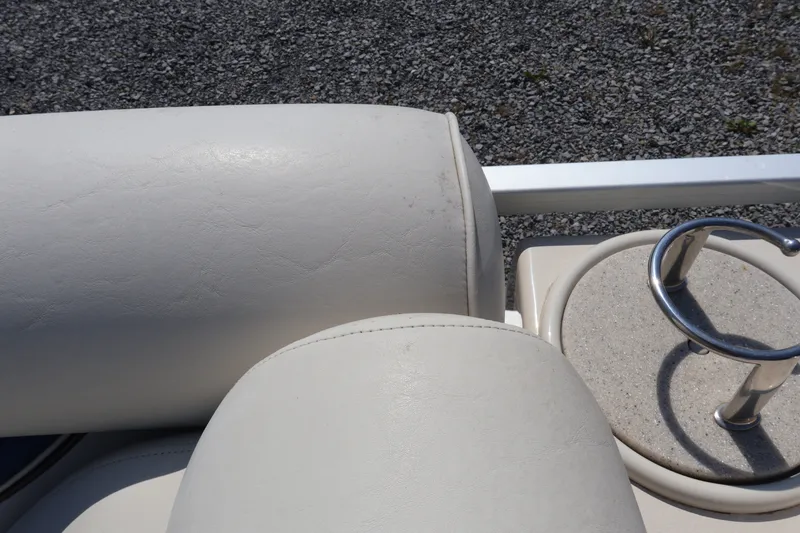Slide: The Image of 2008 Premier 210 Sunsation boat interior with white seating and cup holder. - 56