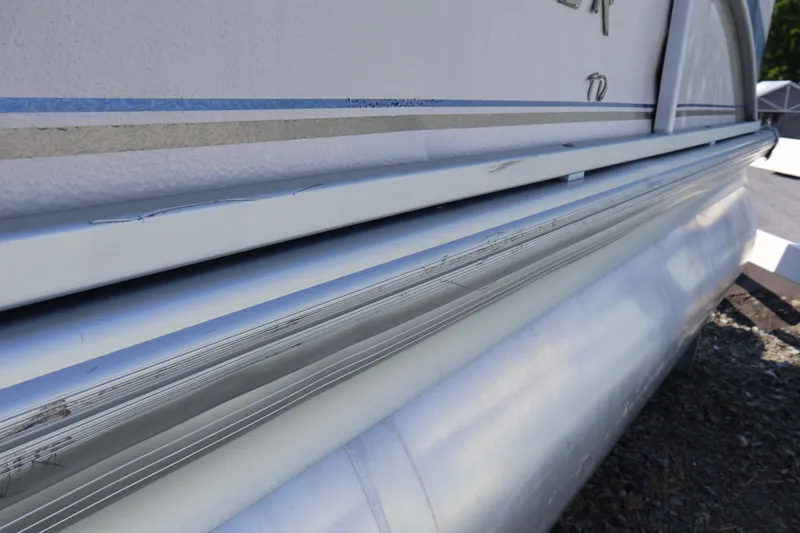 Slide: The Image of Close-up of 2008 Premier 210 Sunsation pontoon boat exterior with visible wear. - 4