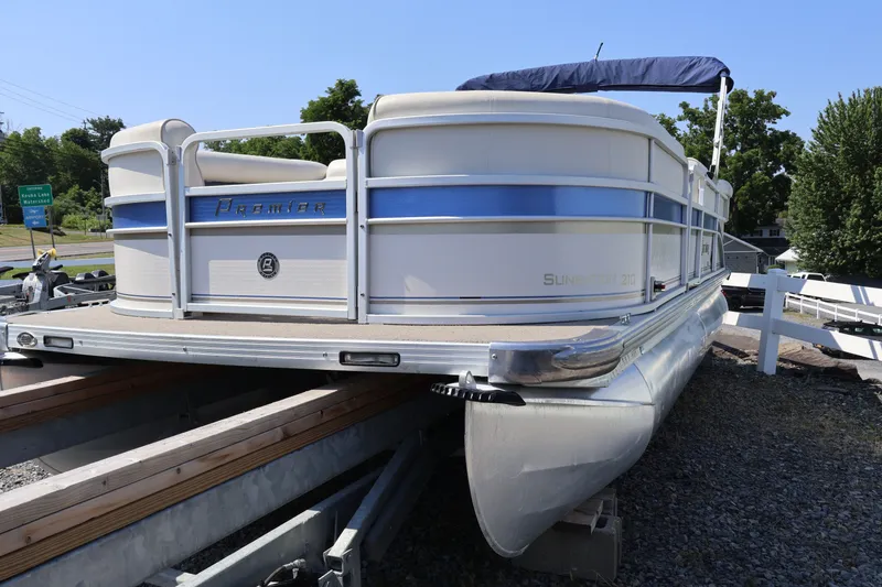 The Image of 2008 Premier 210 Sunsation pontoon boat on trailer, featuring blue and white design. - 0