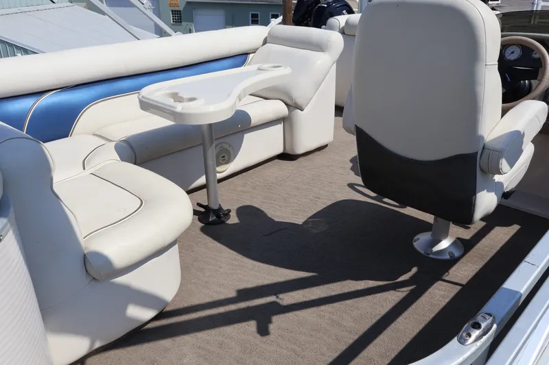 Slide: The Image of 2008 Premier 210 Sunsation boat interior with white seating and table. - 27