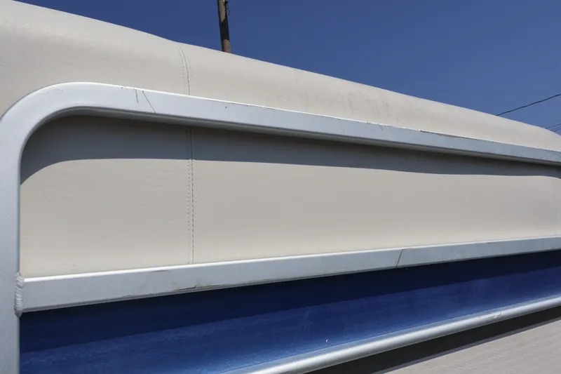 Slide: The Image of 2008 Premier 210 Sunsation boat side view with blue and beige detailing. - 15