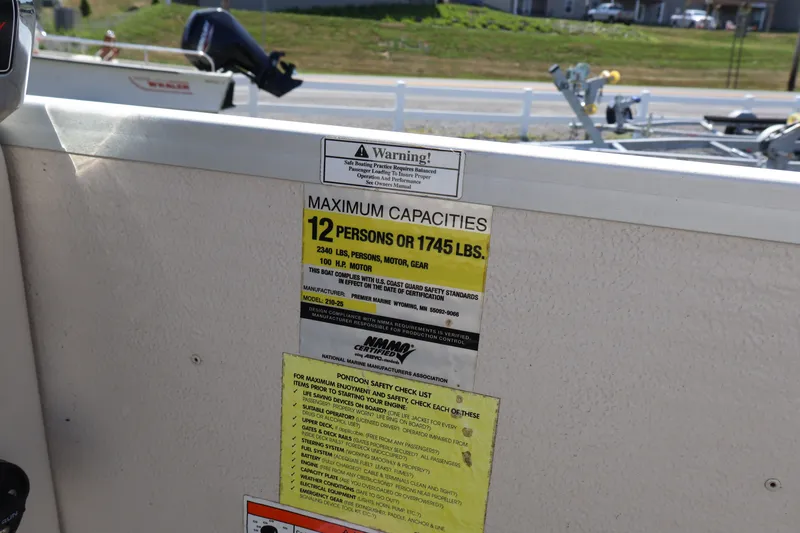 Slide: The Image of 2008 Premier 210 Sunsation capacity label, 12 persons or 1745 lbs, safety instructions visible. - 48