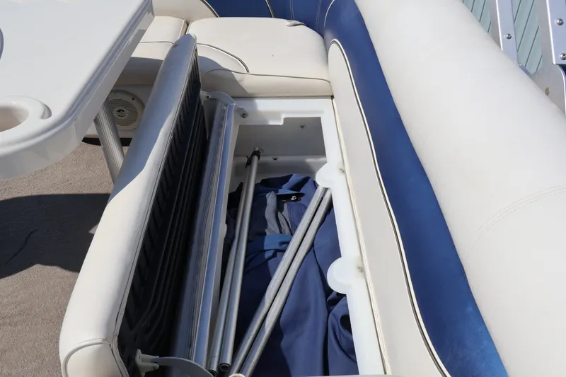 Slide: The Image of Storage compartment in 2008 Premier 210 Sunsation boat with blue and white seating. - 23