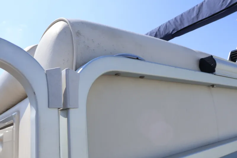 Slide: The Image of 2008 Premier 210 Sunsation boat detail, featuring white upholstery and metal railing under clear sky. - 18
