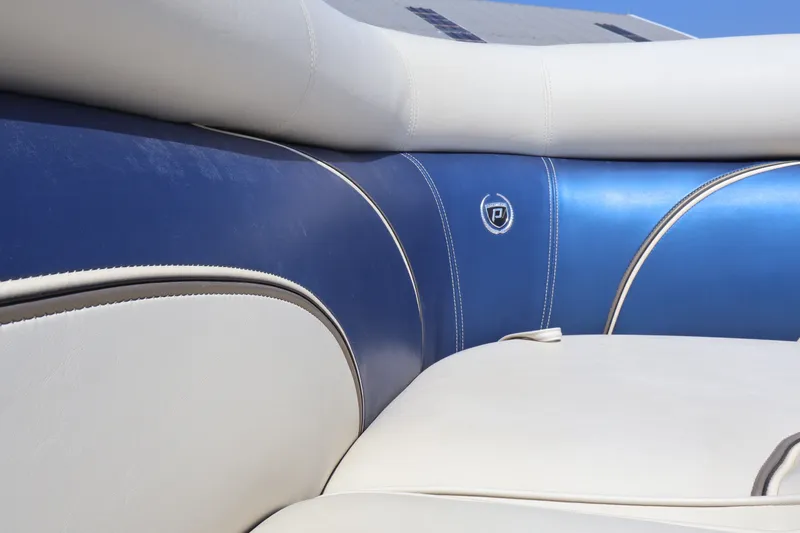 Slide: The Image of 2008 Premier 210 Sunsation boat interior with blue and white cushioned seating. - 41