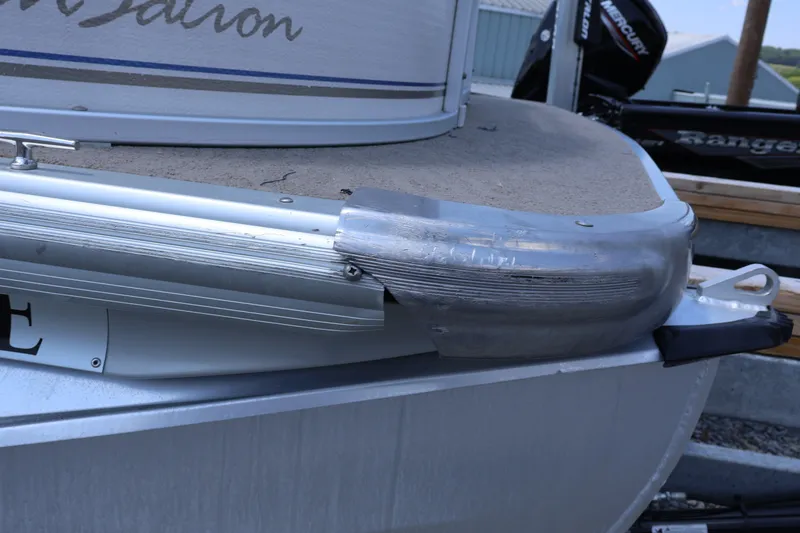 Slide: The Image of The image shows the stern of a 2008 Premier 210 Sunsation boat with metal trim. - 7