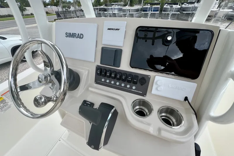 Slide: The Image of 2026 Boston Whaler 250 Dauntless helm with Simrad electronics and Mercury controls. - 20