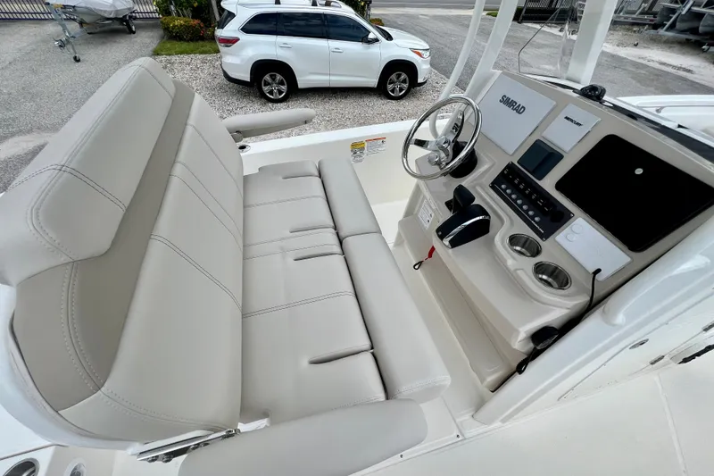 Slide: The Image of 2026 Boston Whaler 250 Dauntless boat interior with steering console and seating. - 17