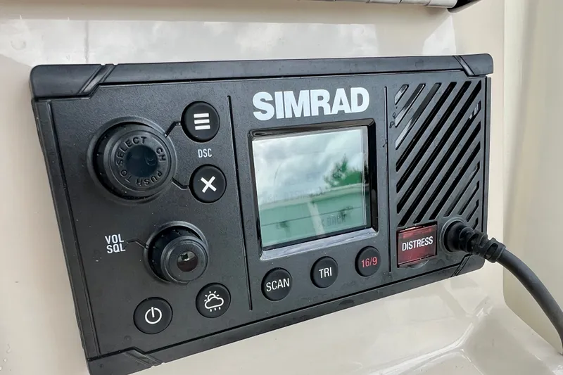 Slide: The Image of Simrad marine radio on 2026 Boston Whaler 250 Dauntless, featuring distress button and controls. - 23