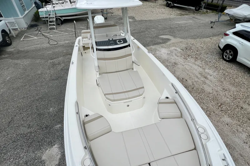 Slide: The Image of 2026 Boston Whaler 250 Dauntless boat with spacious seating, parked outdoors. - 37