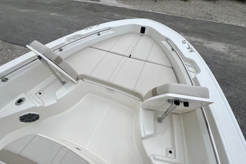 Slide: The Image of 2026 Boston Whaler 250 Dauntless boat interior with cushioned seating and cup holders. - 35