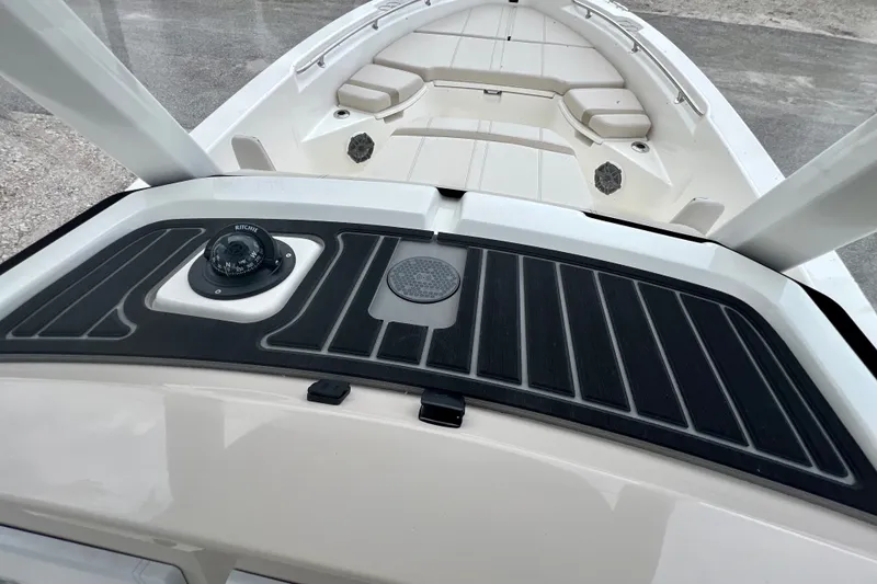 Slide: The Image of 2026 Boston Whaler 250 Dauntless boat dashboard with compass and seating area. - 21