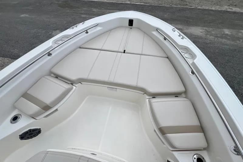 Slide: The Image of 2026 Boston Whaler 250 Dauntless boat interior with cushioned seating and stainless steel railings. - 33