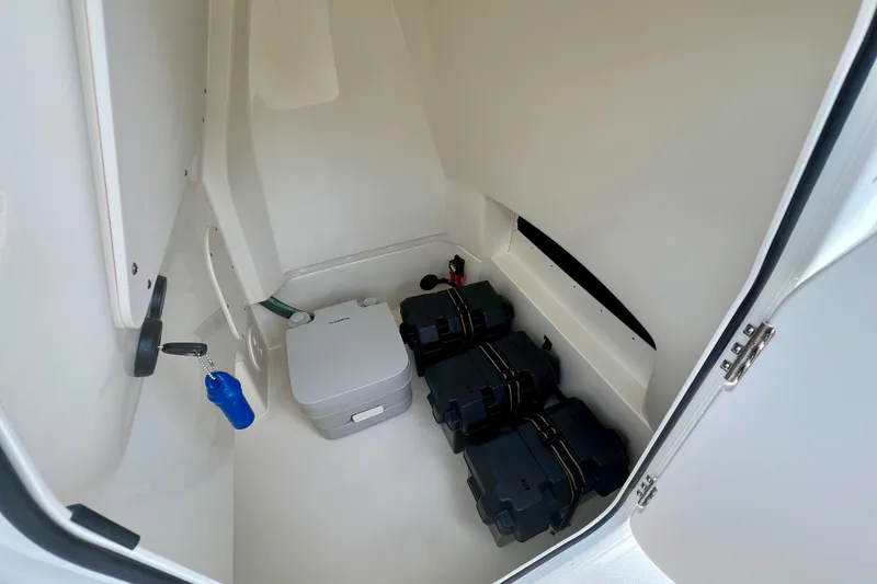 Slide: The Image of Interior storage compartment of 2026 Boston Whaler 250 Dauntless boat, featuring equipment and accessories. - 28