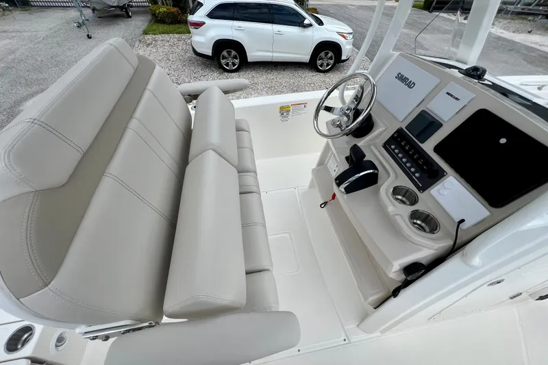 Slide: The Image of 2026 Boston Whaler 250 Dauntless boat interior with helm, steering wheel, and seating. - 16