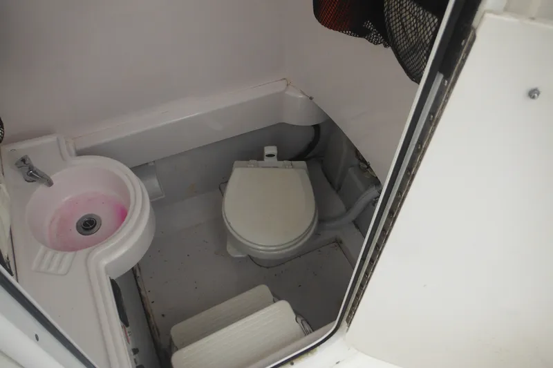 Slide: The Image of Interior of 2006 Southport 26 Center Console boat bathroom with sink and toilet. - 29