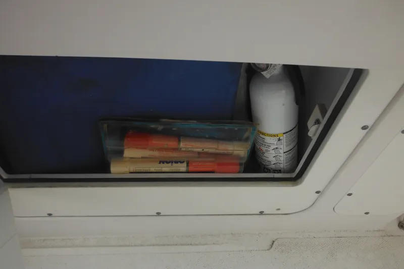 Slide: The Image of Storage compartment on a 2006 Southport 26 Center Console with safety equipment. - 26